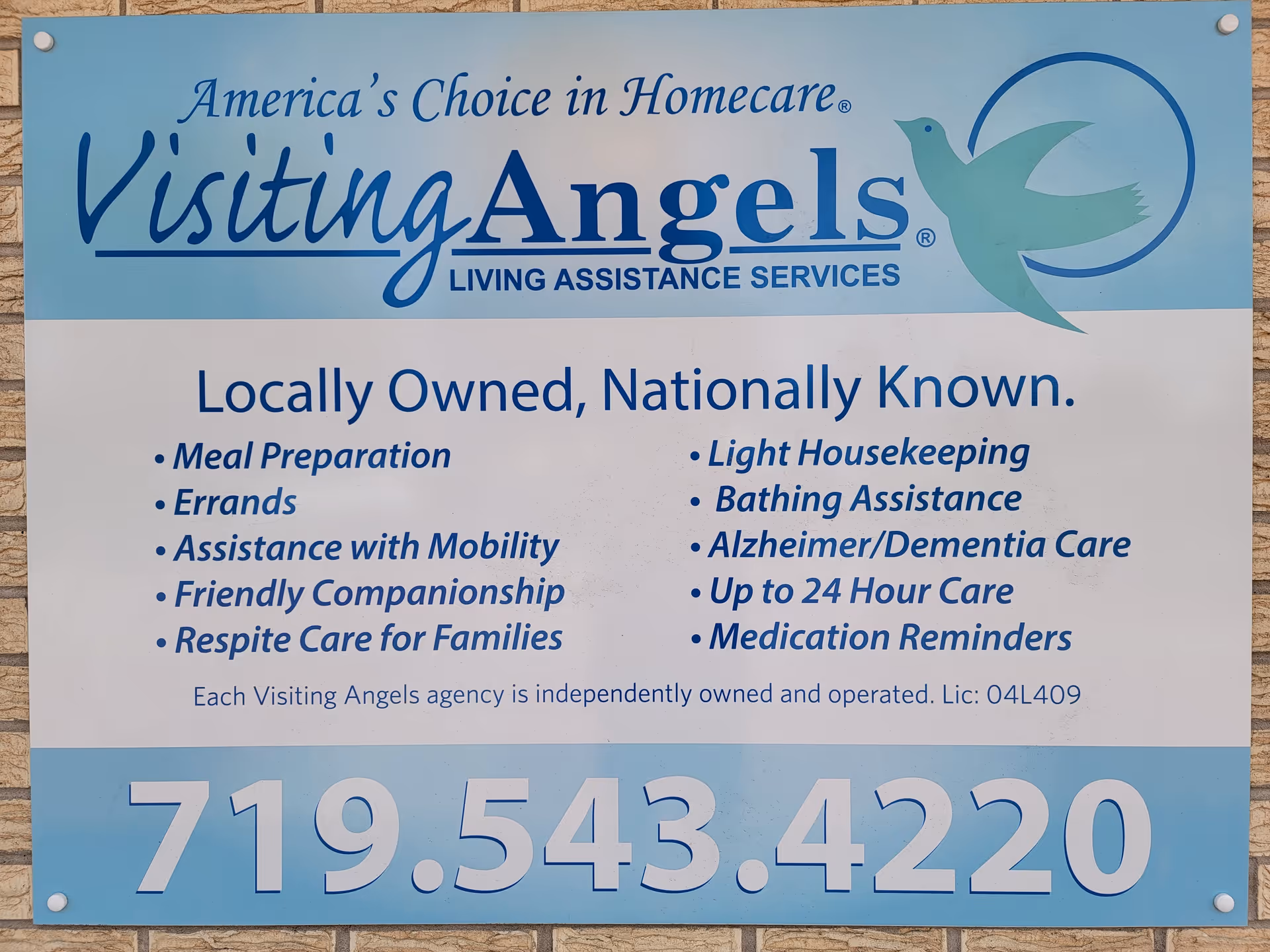 Outdoor sign for Visiting Angels Senior Home Care displays services and contact number.