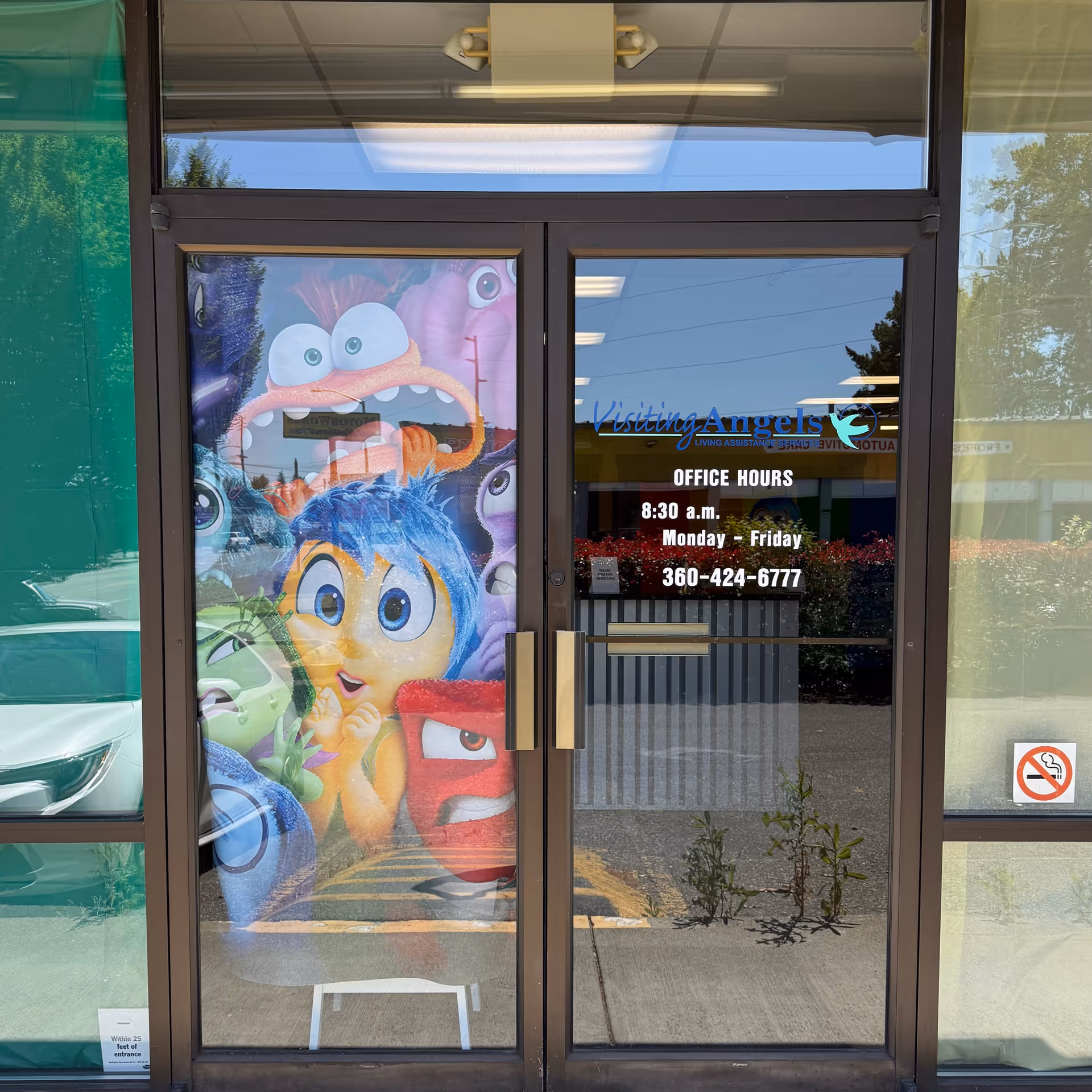 Front entrance showing Visiting Angels signage and colorful mural on left glass panel.