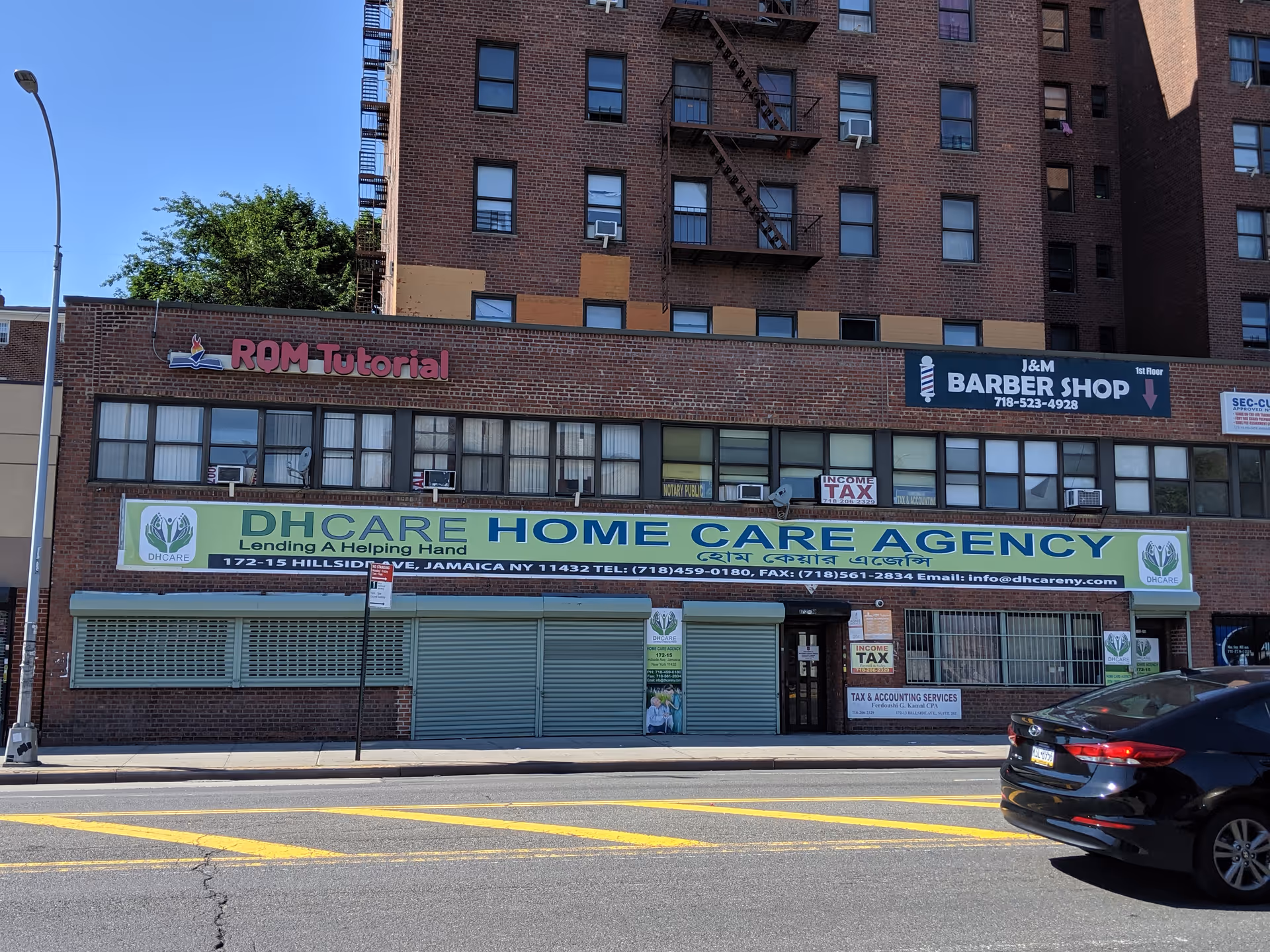 Brick building with a large DHCare Home Care Agency banner across the storefront.