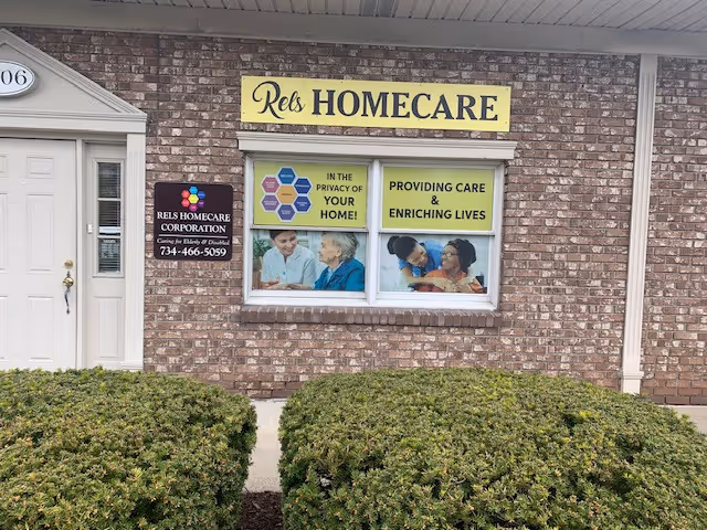 Brick building exterior with a Rels Homecare sign and promotional window panels.