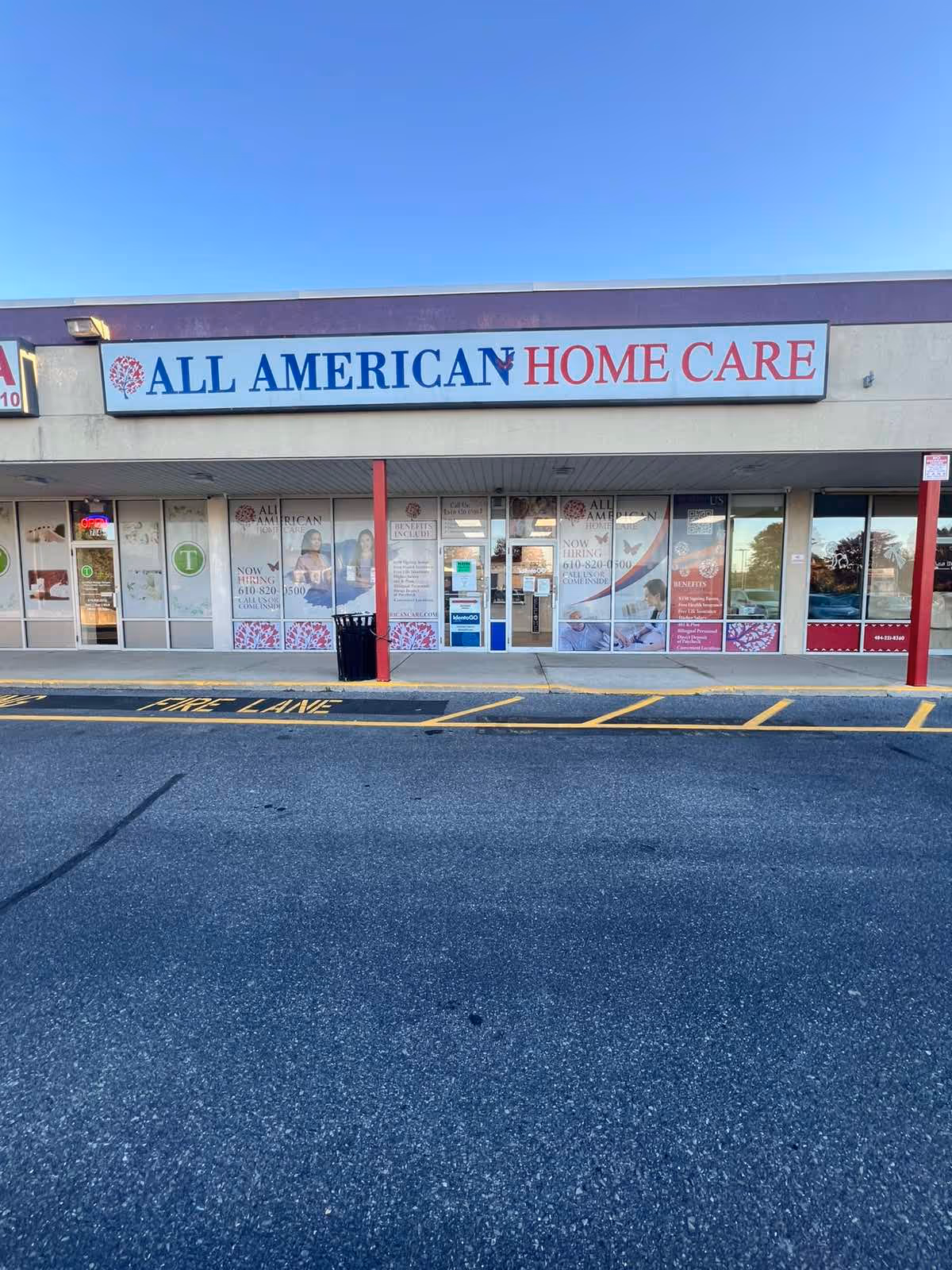 Exterior view of All American Home Care storefront with large sign and glass doors in Allentown.
