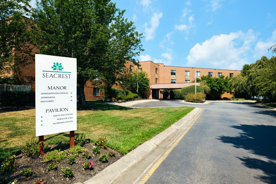 Exterior view of Seacrest Rehabilitation and Healthcare Center with sign and driveway.