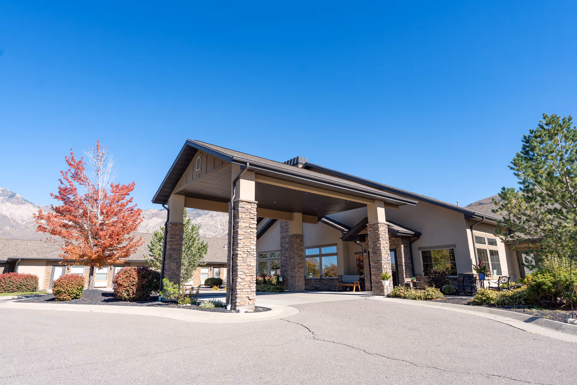 Quail Meadow Assisted Living exterior entrance with a covered drop-off canopy and landscaping