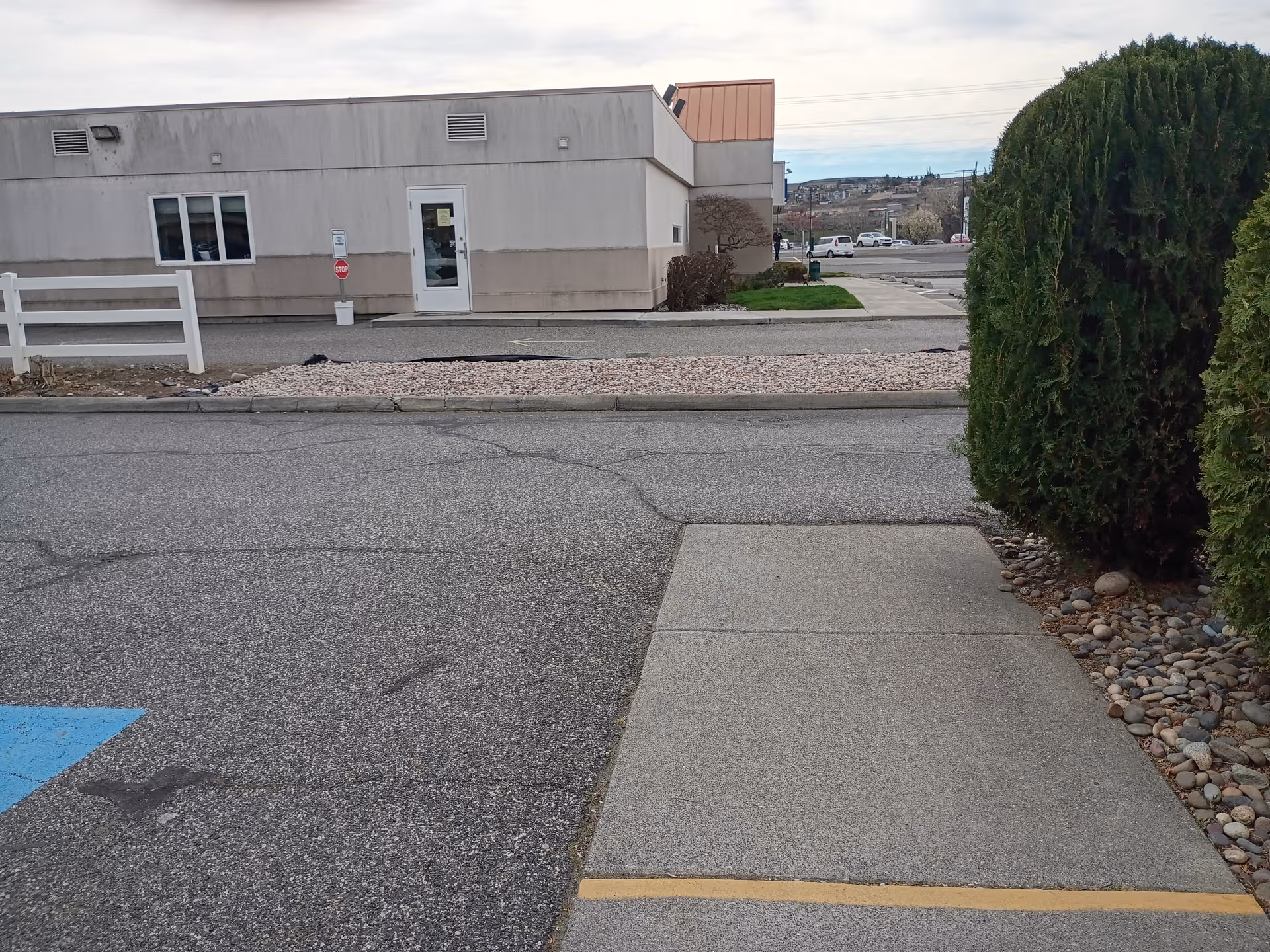Exterior view of Life Care Center of Richland, showing the entrance and surrounding landscape.