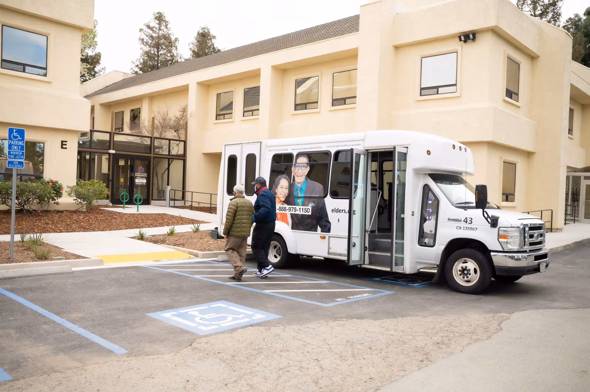 Exterior view of Center for Elders' Independence PACE Concord Center with a parked bus.