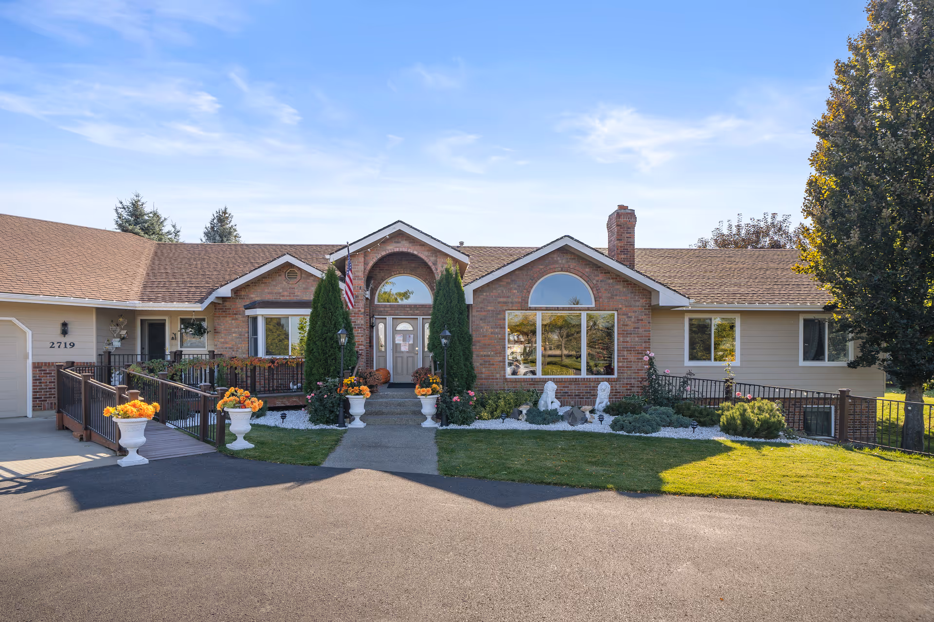 Providence Adult Family Home front exterior with landscaped entrance and decorative planters.