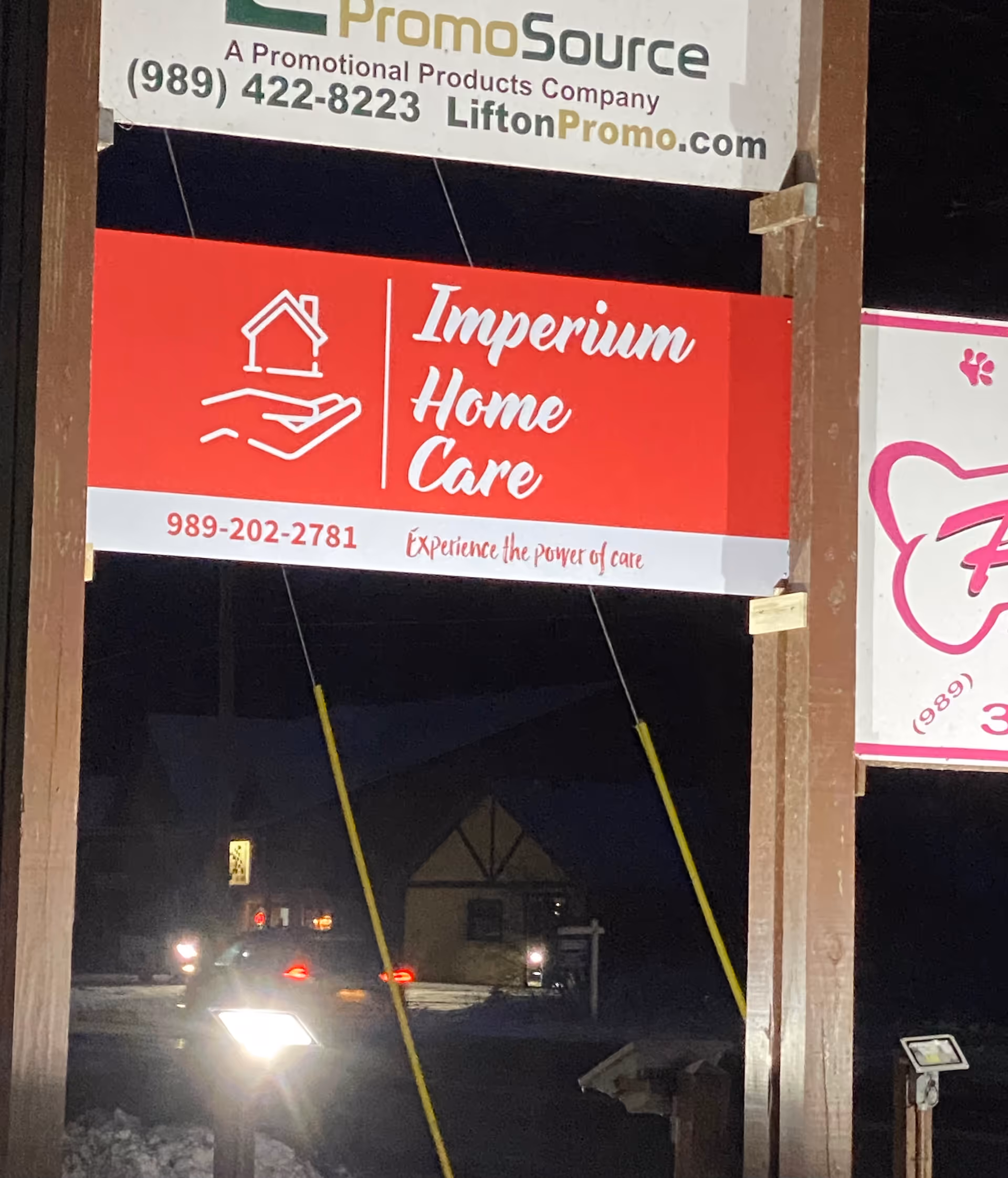 Night exterior signboard for Imperium Home Care on a building front.