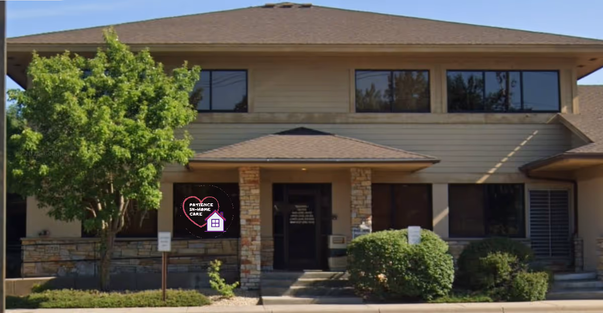 Two-story beige building with stone accents and a circular care logo on the front window.