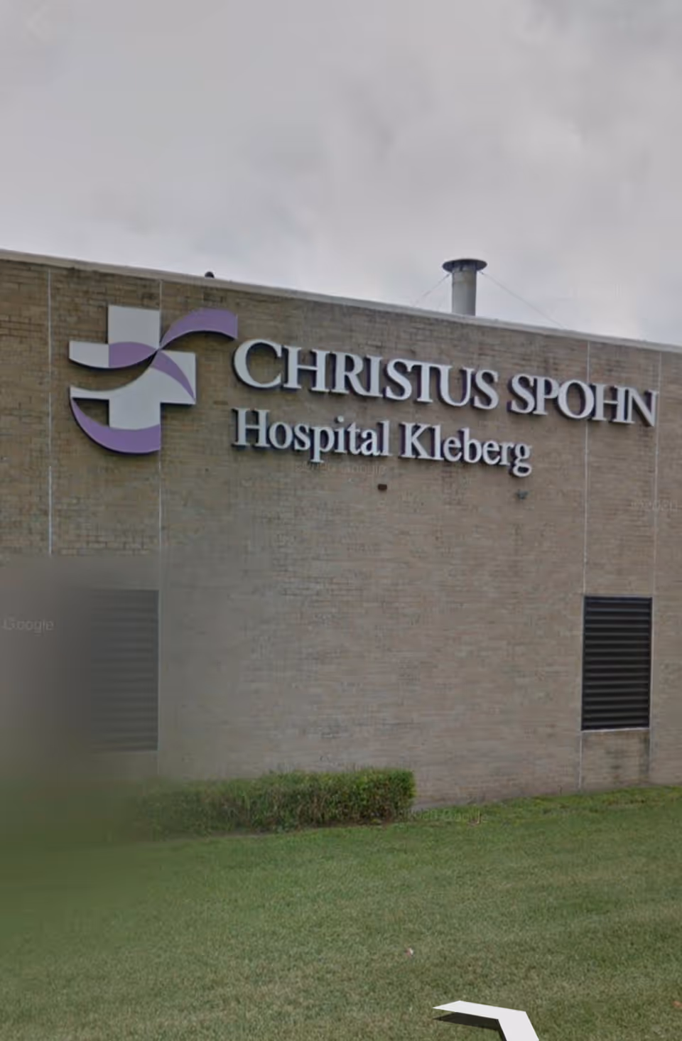 Exterior view of a brick hospital building with a large Christus Spohn Hospital sign.