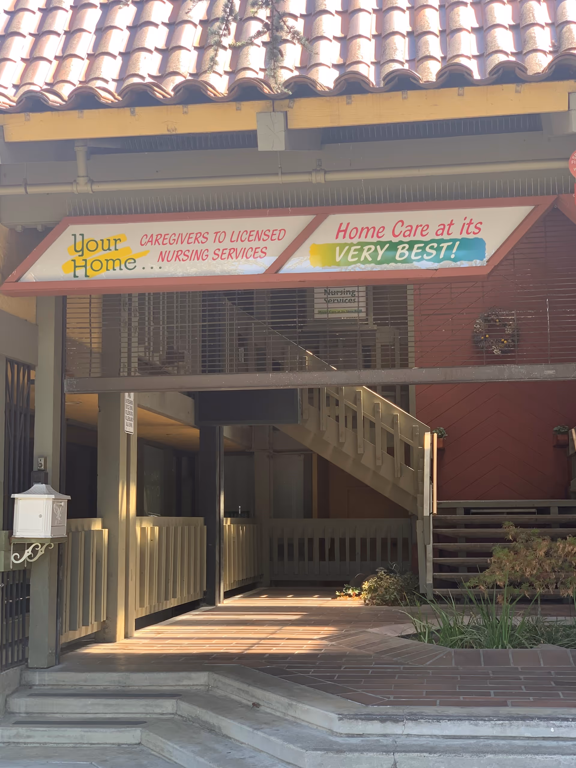 Front exterior of a senior care facility with a colorful Your Home sign.