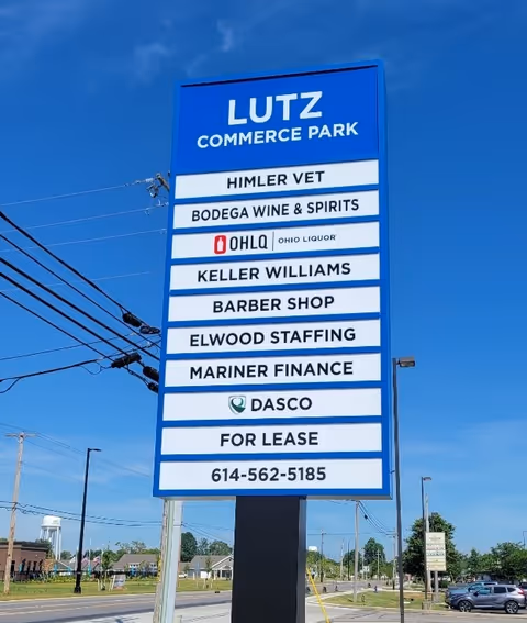 Tall blue outdoor signboard listing tenants including DASCO in Marysville against a clear sky.