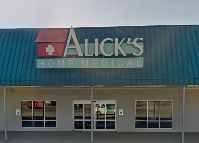 Exterior storefront displaying Alick's Home Medical sign and glass doors.