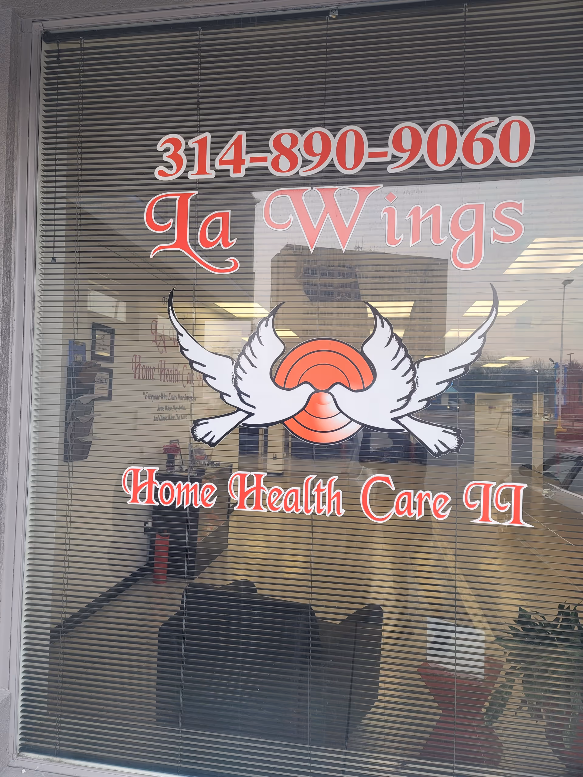 Storefront window shows La Wings Home Health Care II sign with wings logo.