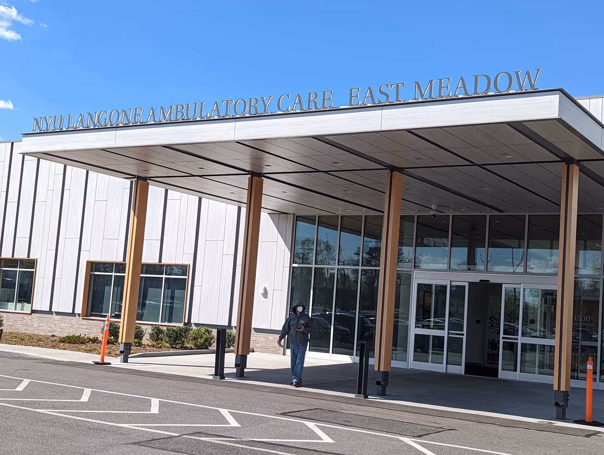 Front exterior of NYU Langone Ambulatory Care East Meadow with glass entry and canopy.