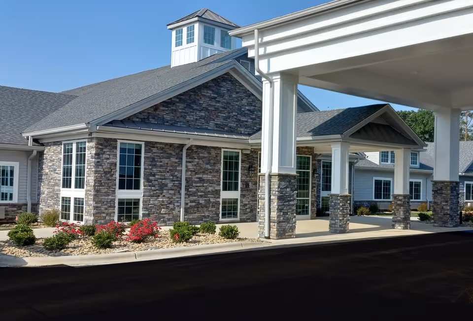 Front view of The Landings of Rockingham with stone facade and covered entrance.