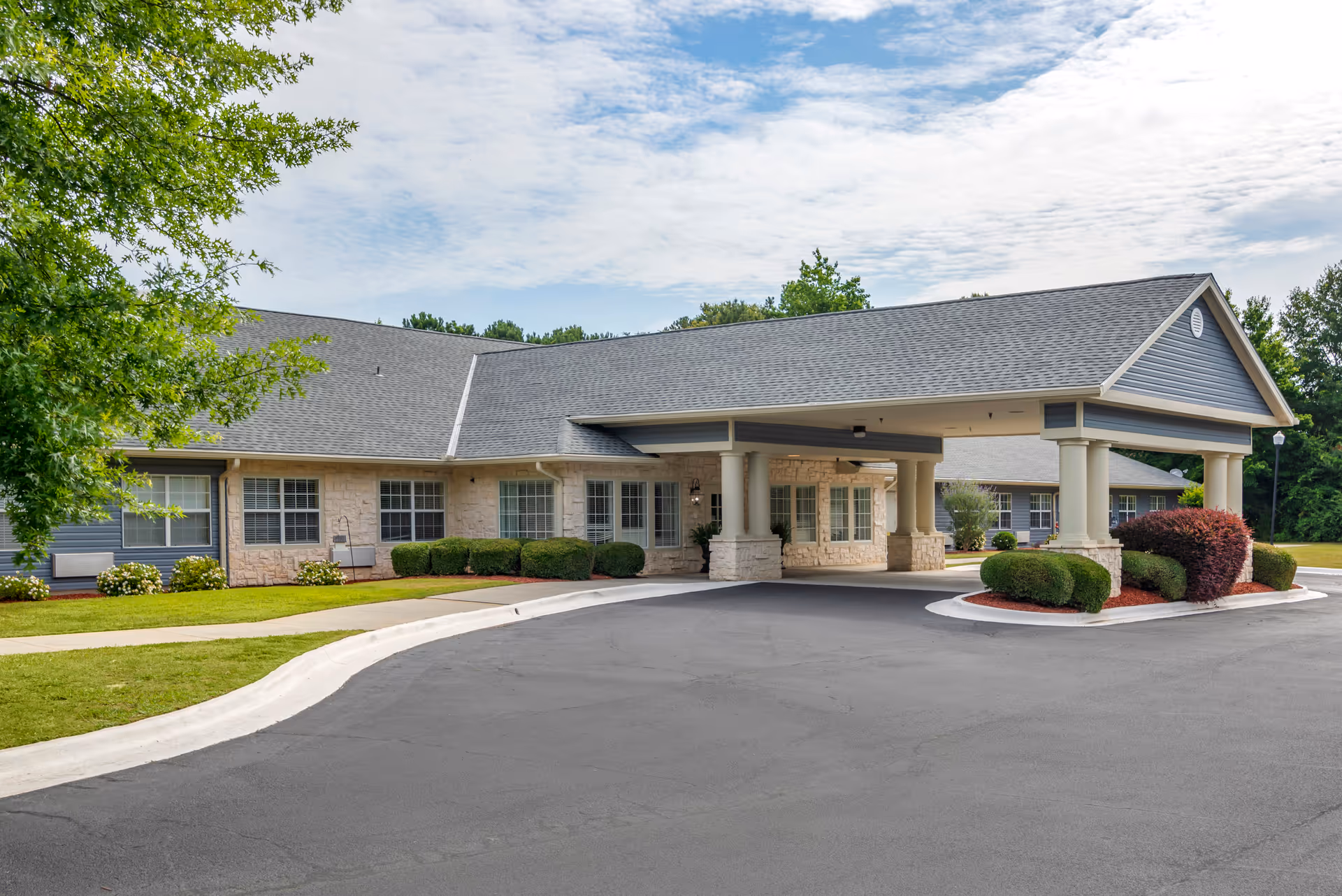 Brookdale Columbus senior living facility exterior with front entrance, driveway, and manicured landscaping.