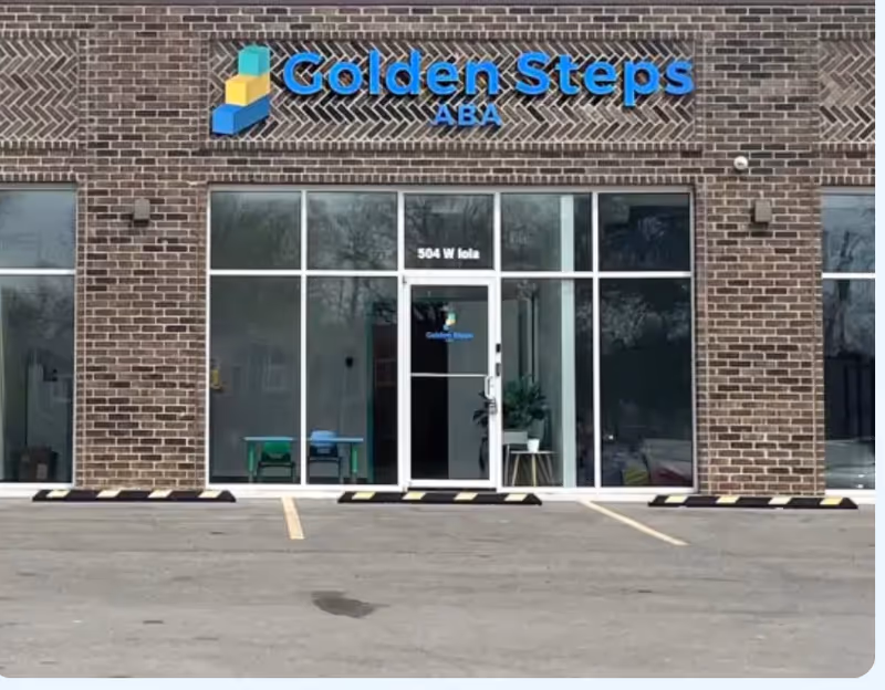 Brick-front building with Golden Steps ABA sign and glass storefront entrance.