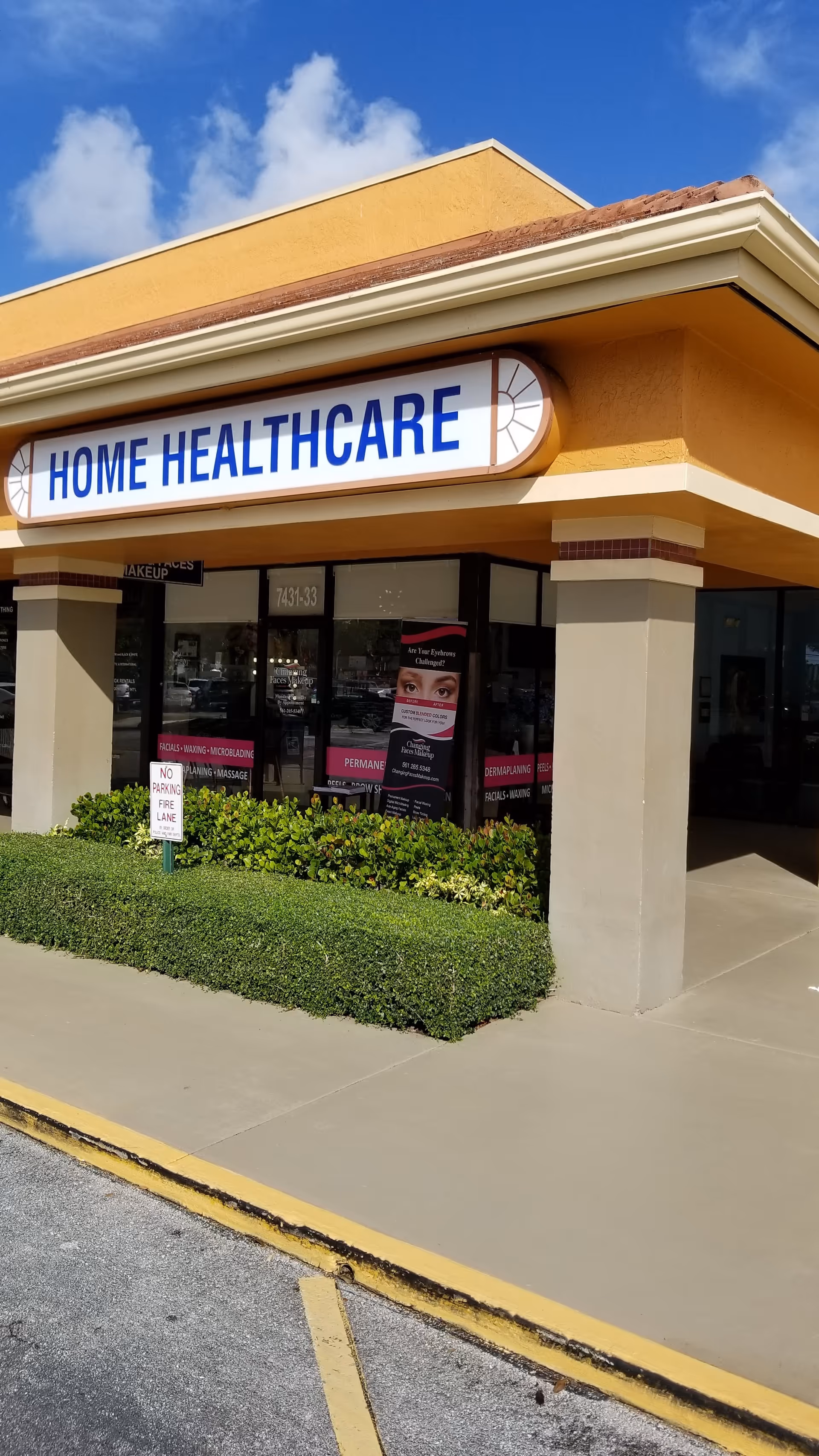 Exterior storefront of a Home Healthcare clinic with signage, glass windows, and shrubs.