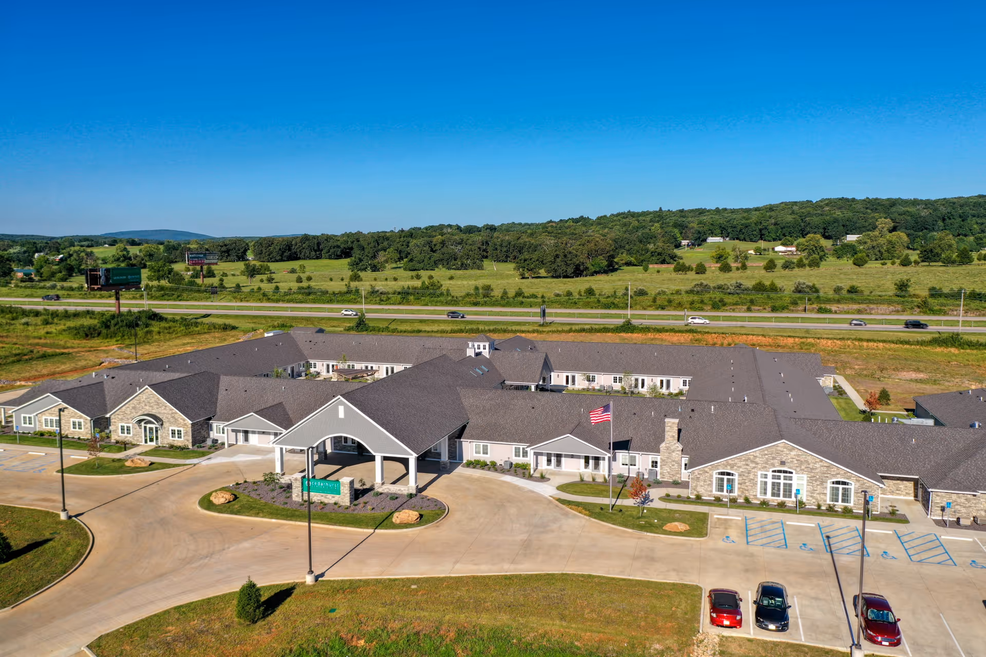 Aerial view of Cedarhurst Senior Living of Farmington's exterior and parking lot.