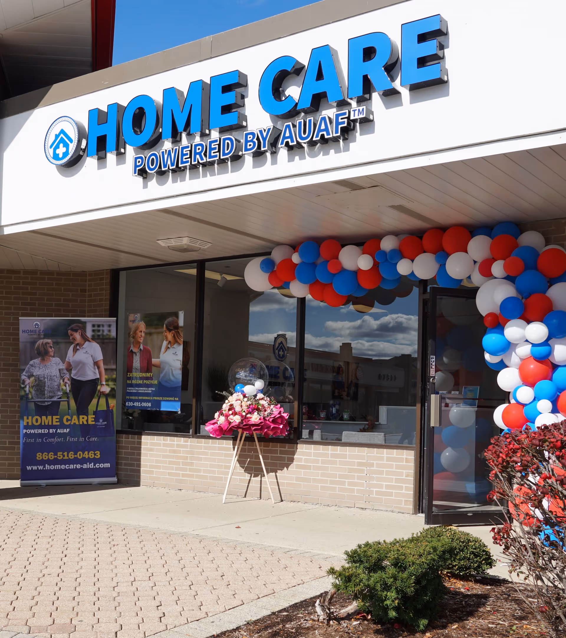 Exterior storefront for Home Care powered by AUAF, adorned with balloons.