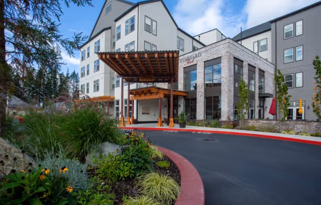 Vineyard Park of Covington exterior with glass entrance and landscaped canopy entry.