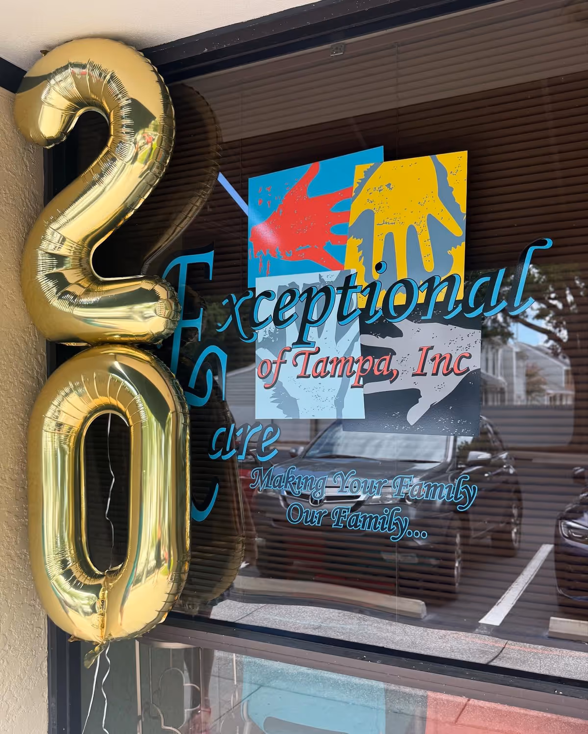 Exterior of Exceptional Care of Tampa, Inc. with gold balloons by the window