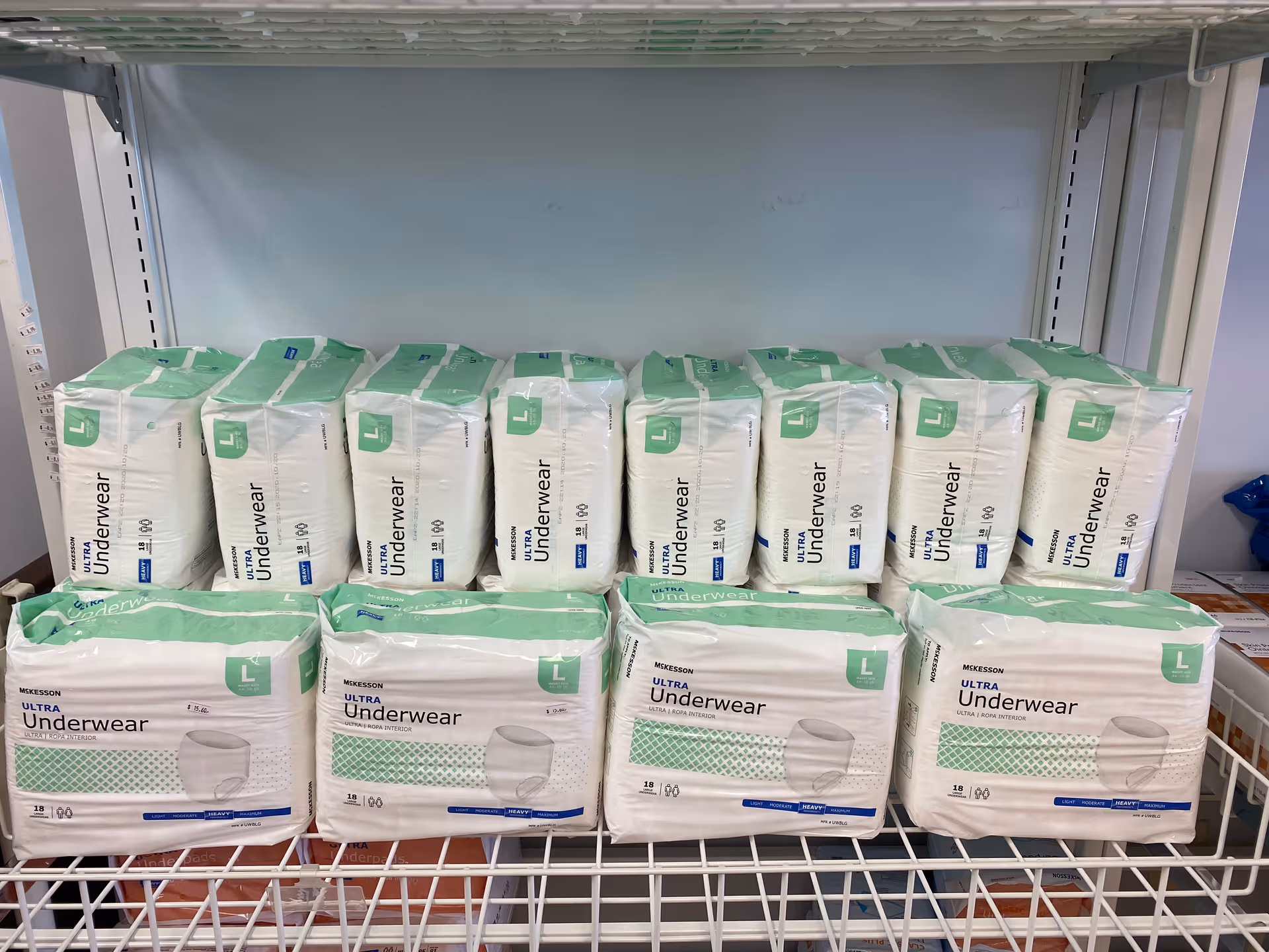 Shelves filled with white Ultra Underwear packages in a storage room.