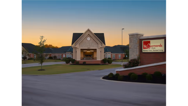Exterior view of St. Bernards Villa entrance with sign at sunset.