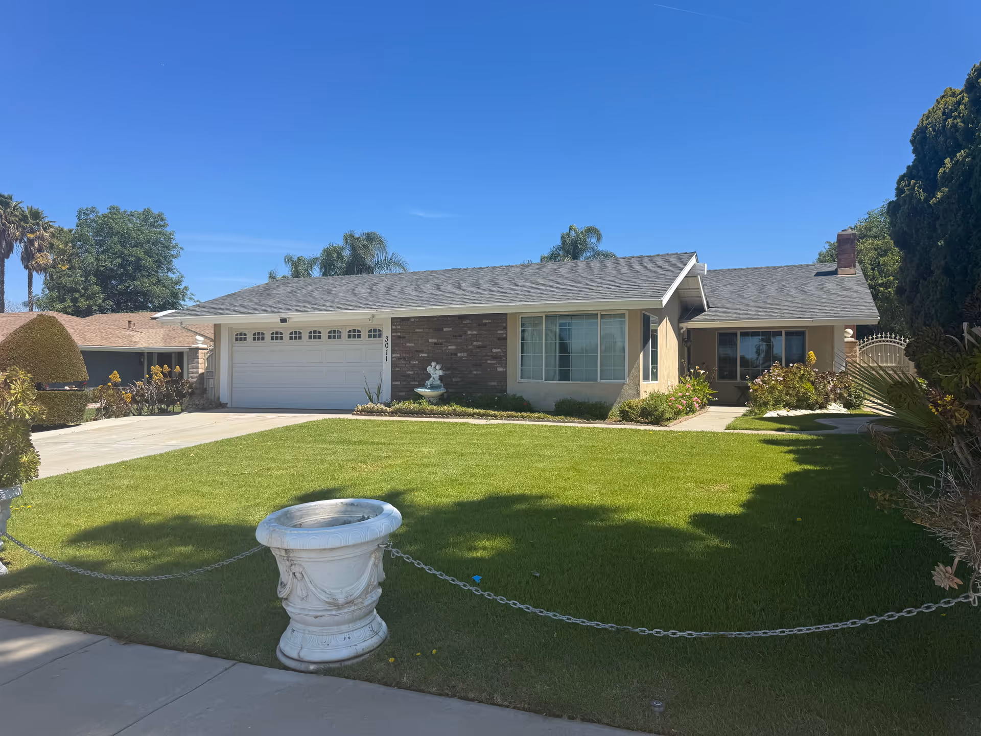 Single-story residential front of Villa Anne with a manicured lawn and two-car garage.