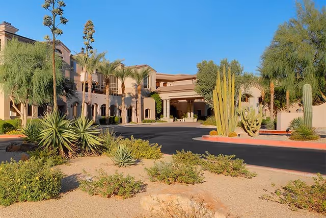 Exterior view of West Bend Nursing and Rehabilitation with desert landscaping and a curved entrance drive.