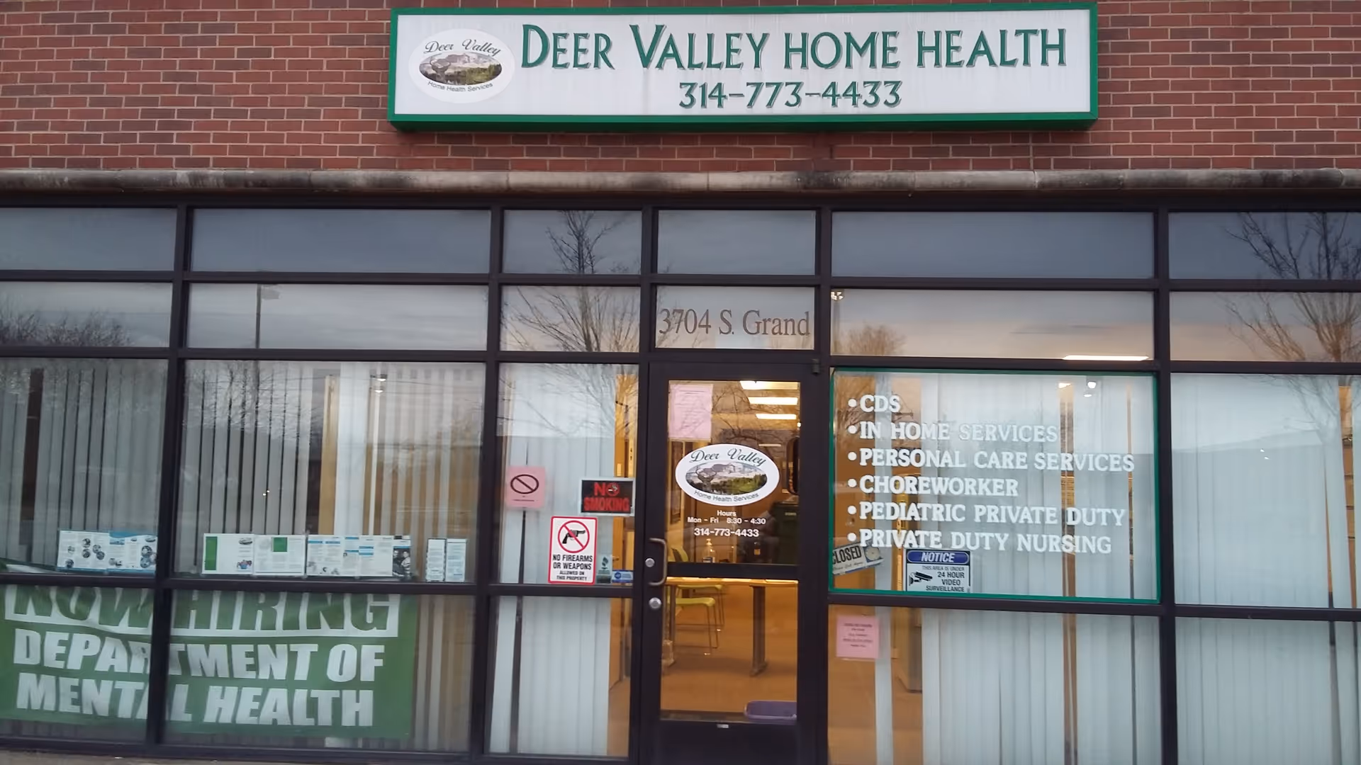 Front view of Deer Valley Home Health Services storefront with sign and glass doors.