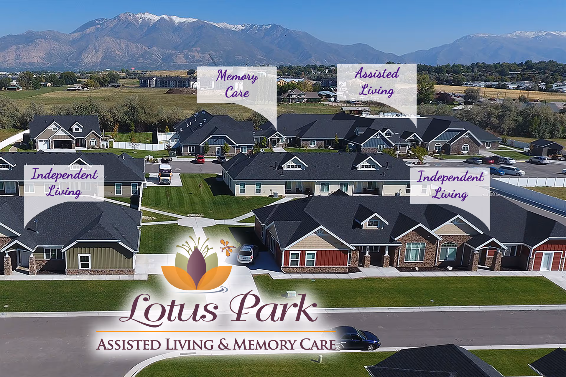 Aerial view of Lotus Park Assisted Living & Memory Care with multiple buildings and distant mountains.
