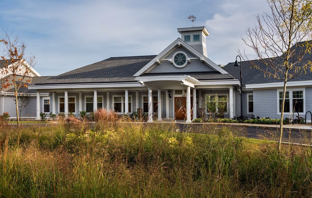 Bridges by EPOCH Mashpee exterior building with columns and landscaped front entrance.