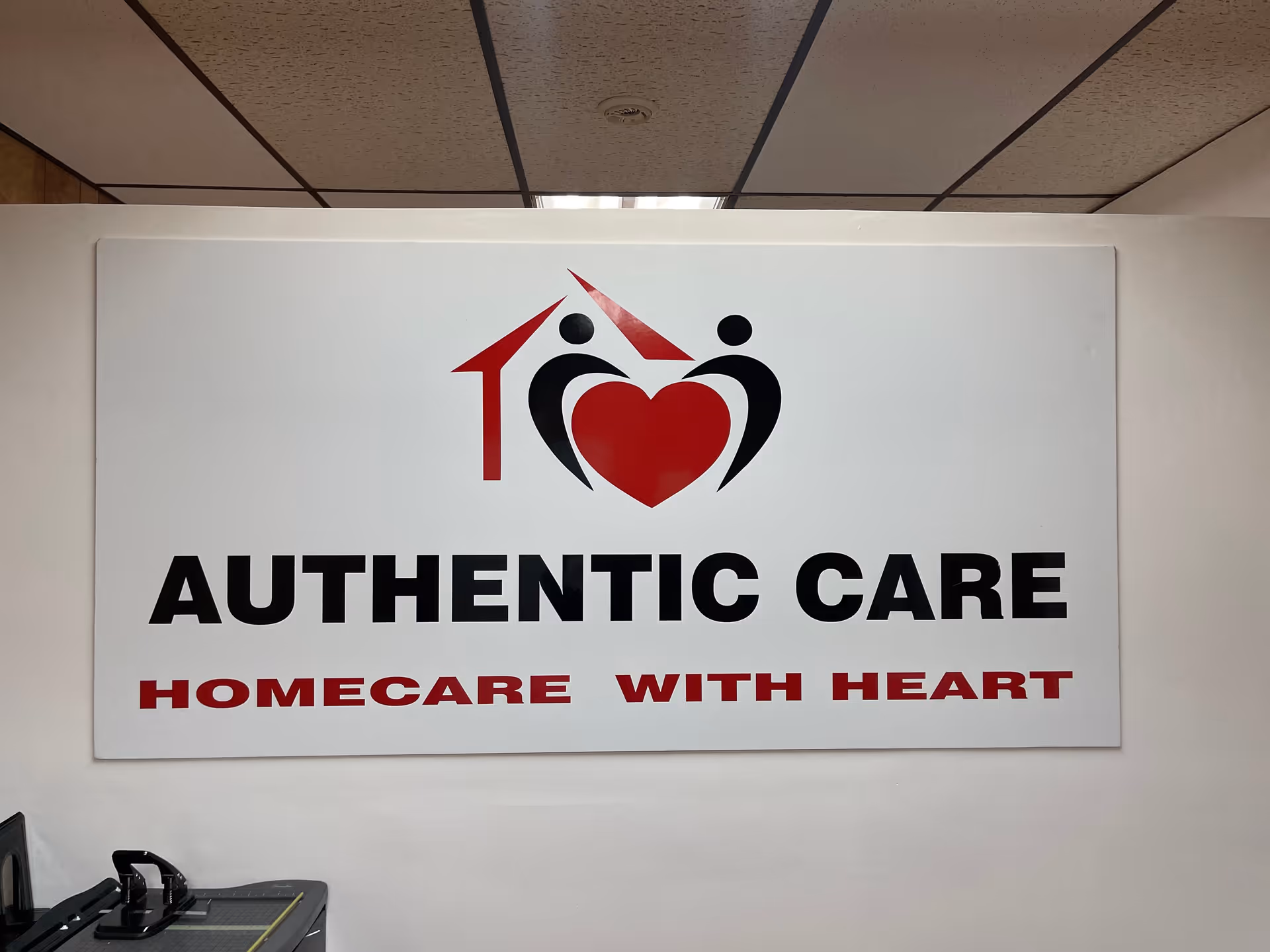 Large wall sign reads AUTHENTIC CARE with a heart logo and tagline.
