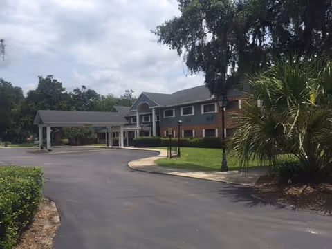 Exterior view of Heavenly Arm/Excellence II senior living facility with driveway and entrance.