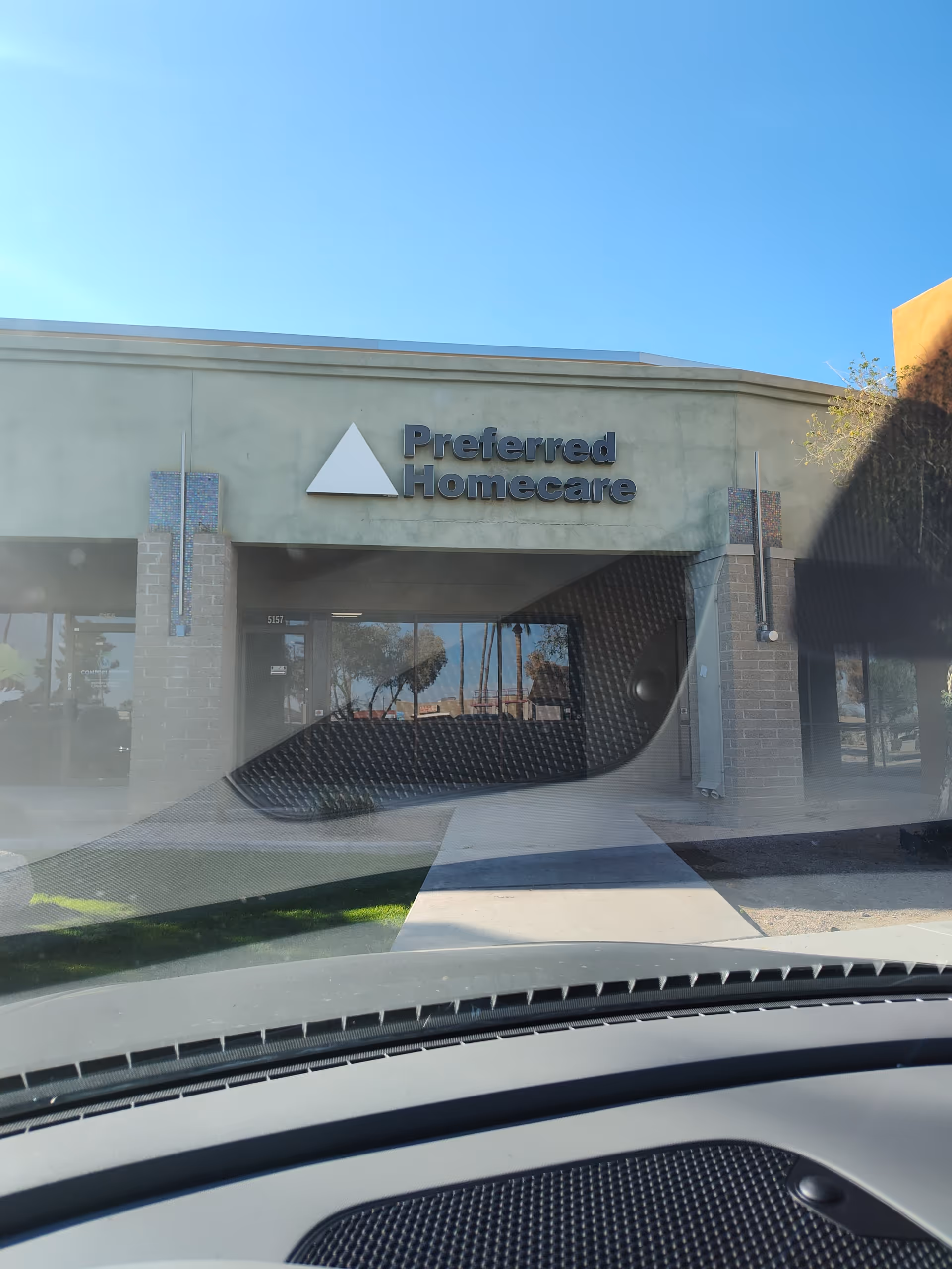 Front exterior view of Preferred Homecare Glendale building with entrance walkway and clear sky.