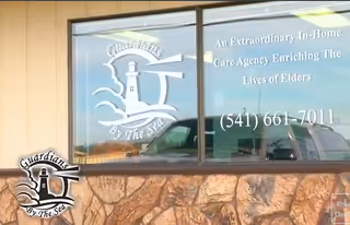Exterior view of Guardians by the Sea facility with logo on a stone wall window.