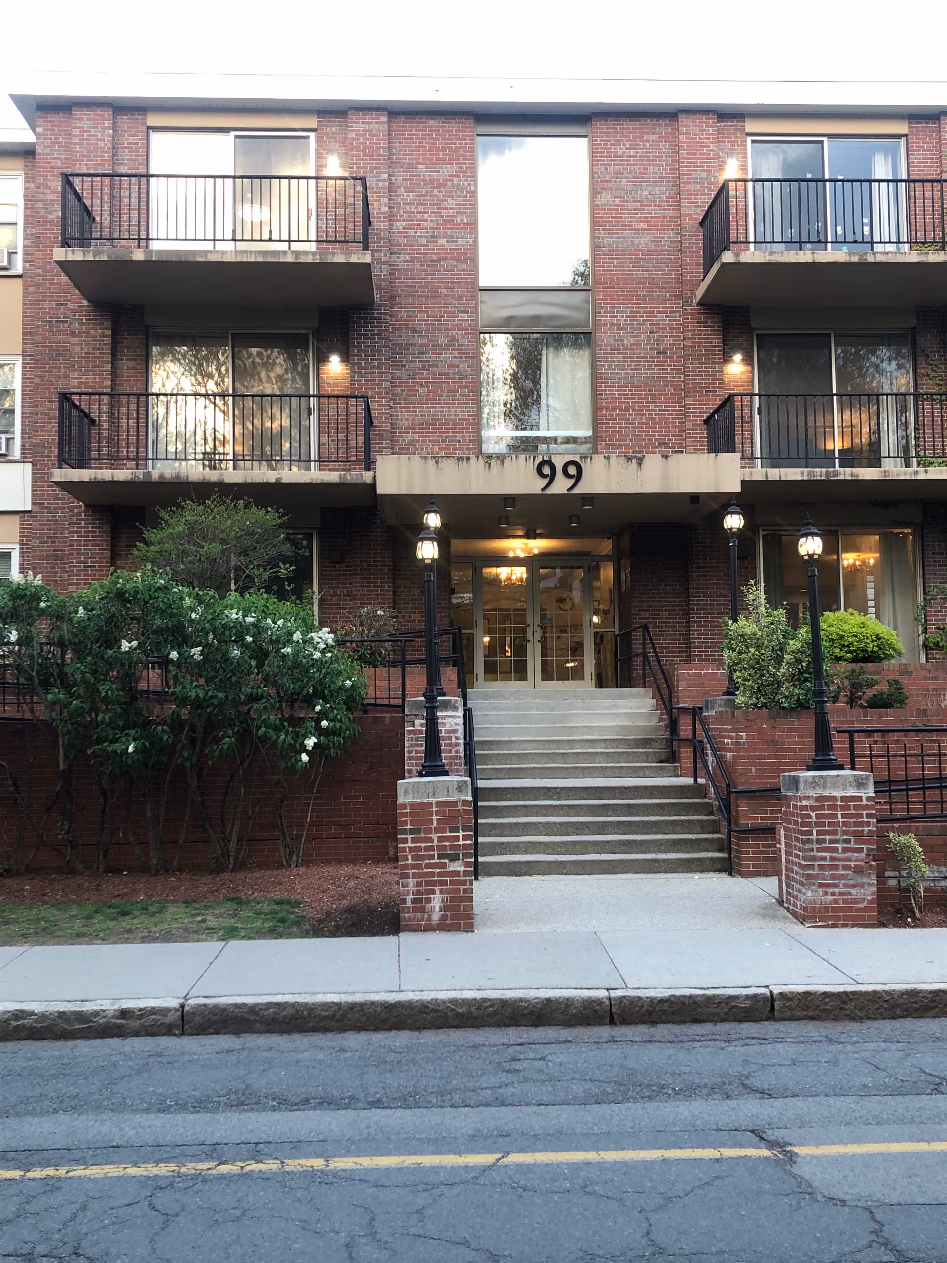 CareOne at Brookline exterior brick building with stairs, balconies, and entrance.