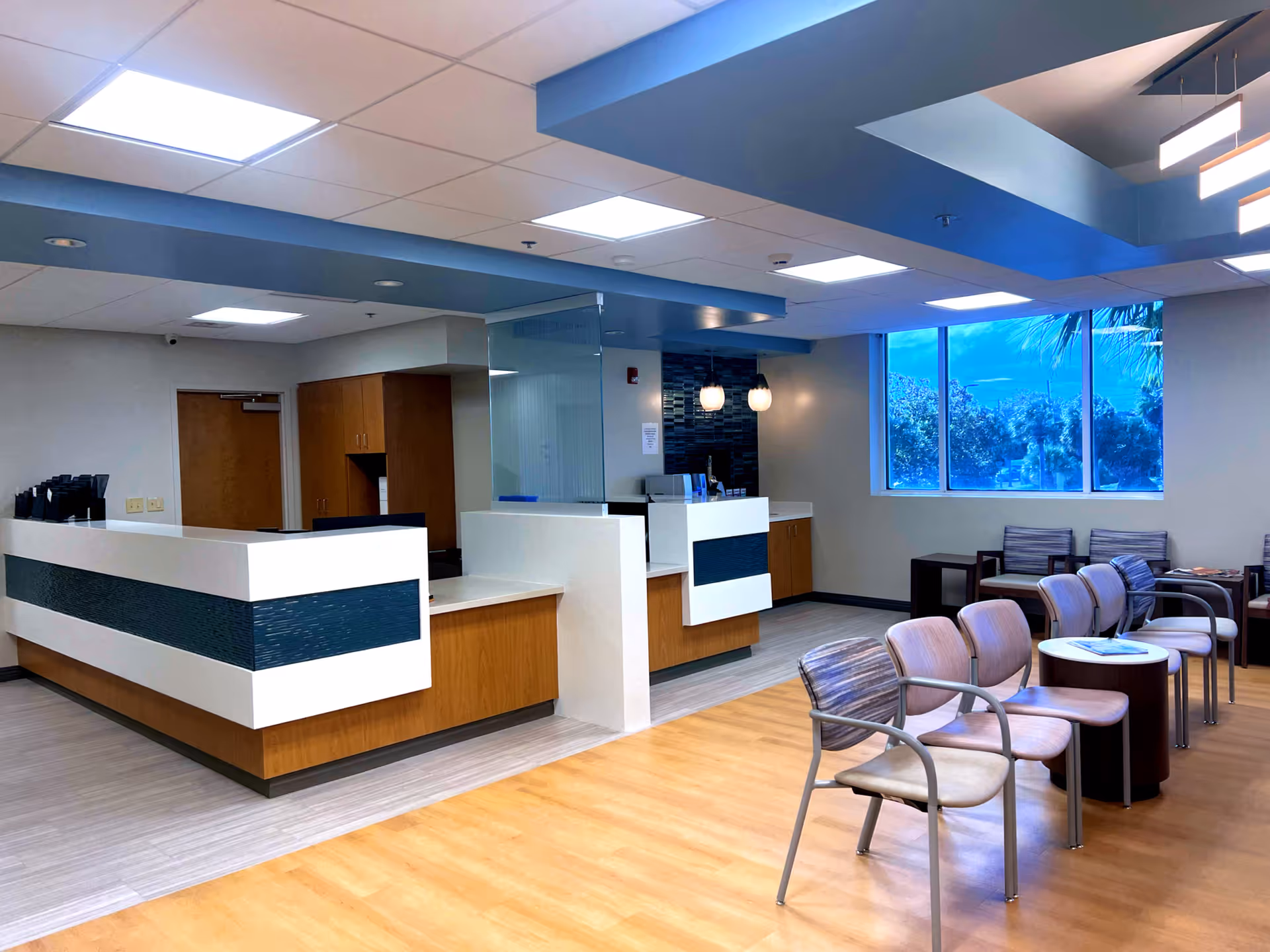 Modern reception area of Jacksonville Beach Surgery Center with seating and large window view