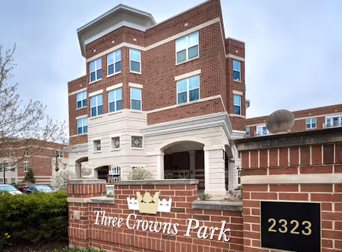 Three Crowns Park building entrance with brick exterior and front sign.