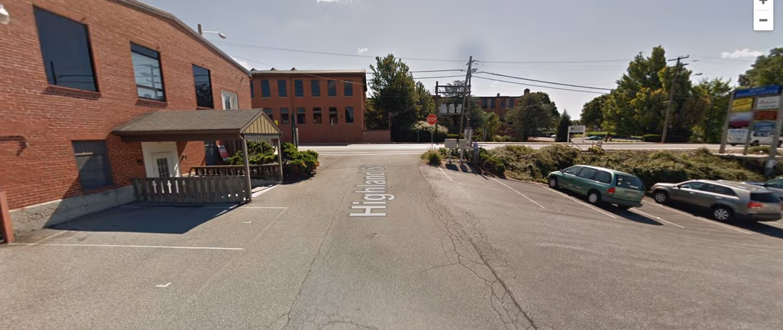 Parking lot in front of a brick senior care facility along Highland Street