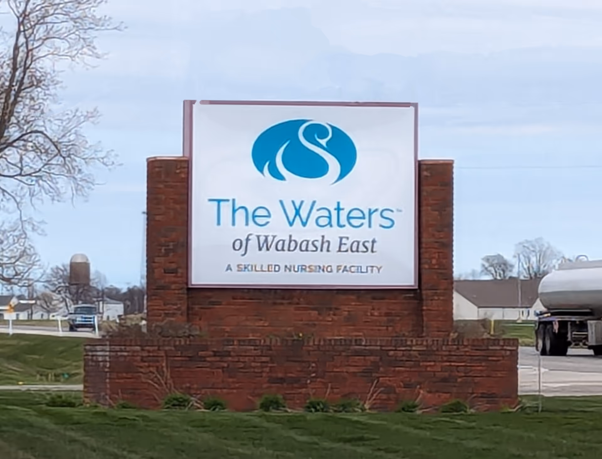 Exterior sign for The Waters of Wabash East nursing facility on brick pedestal
