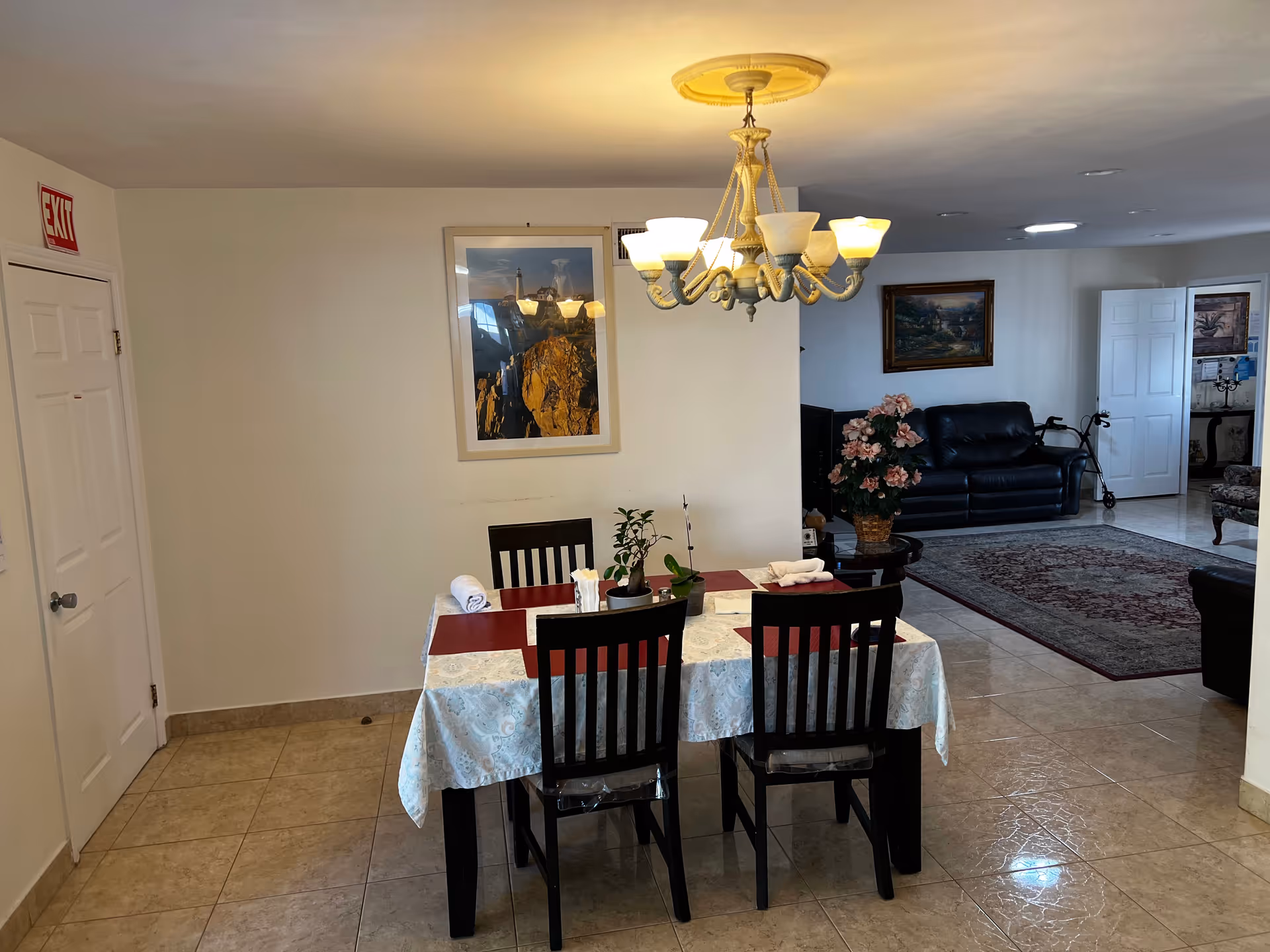 A dining room area with a table set for four in a senior living facility.