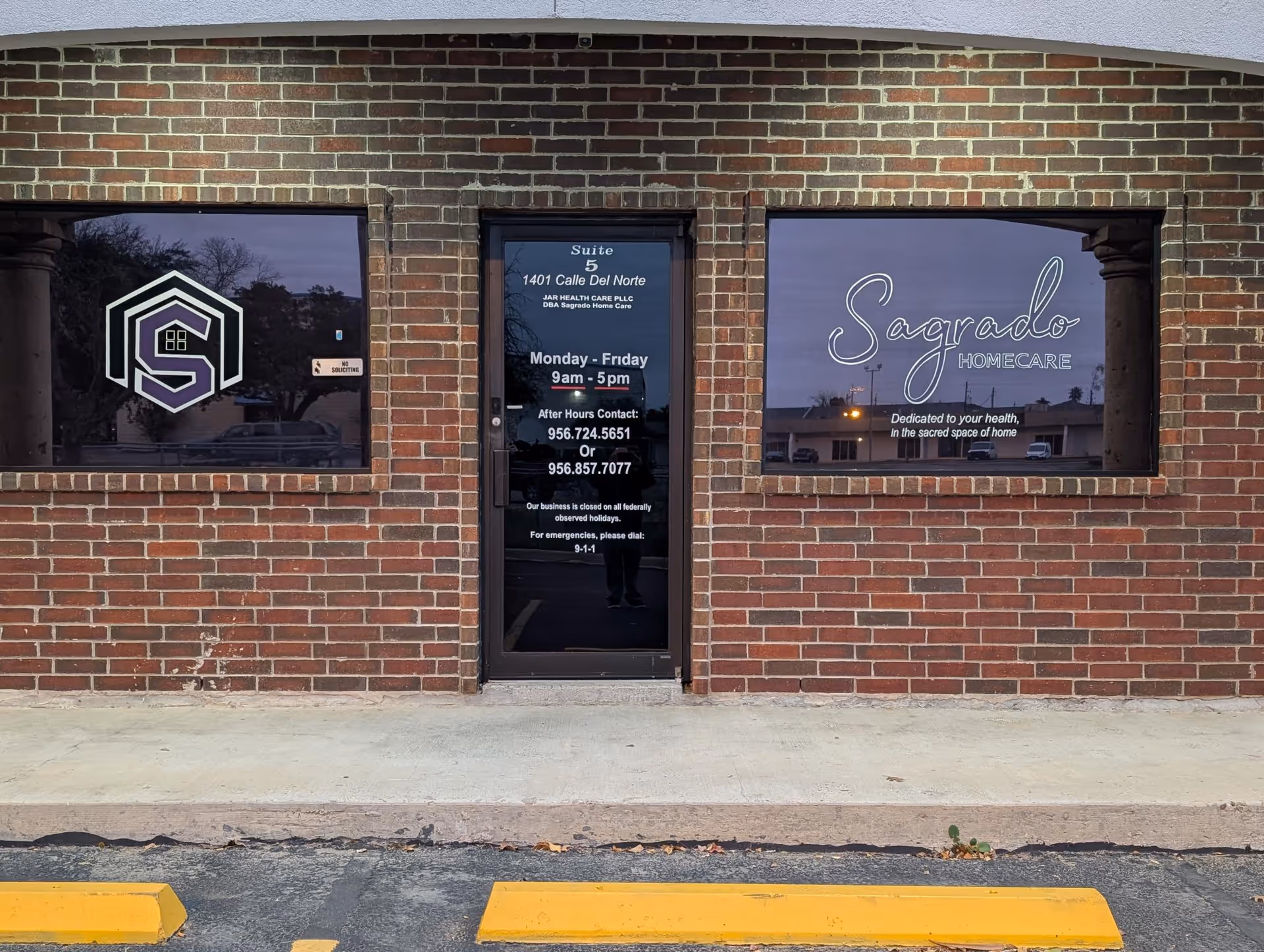 Brick storefront with glass windows displaying Sagrado Homecare signage.