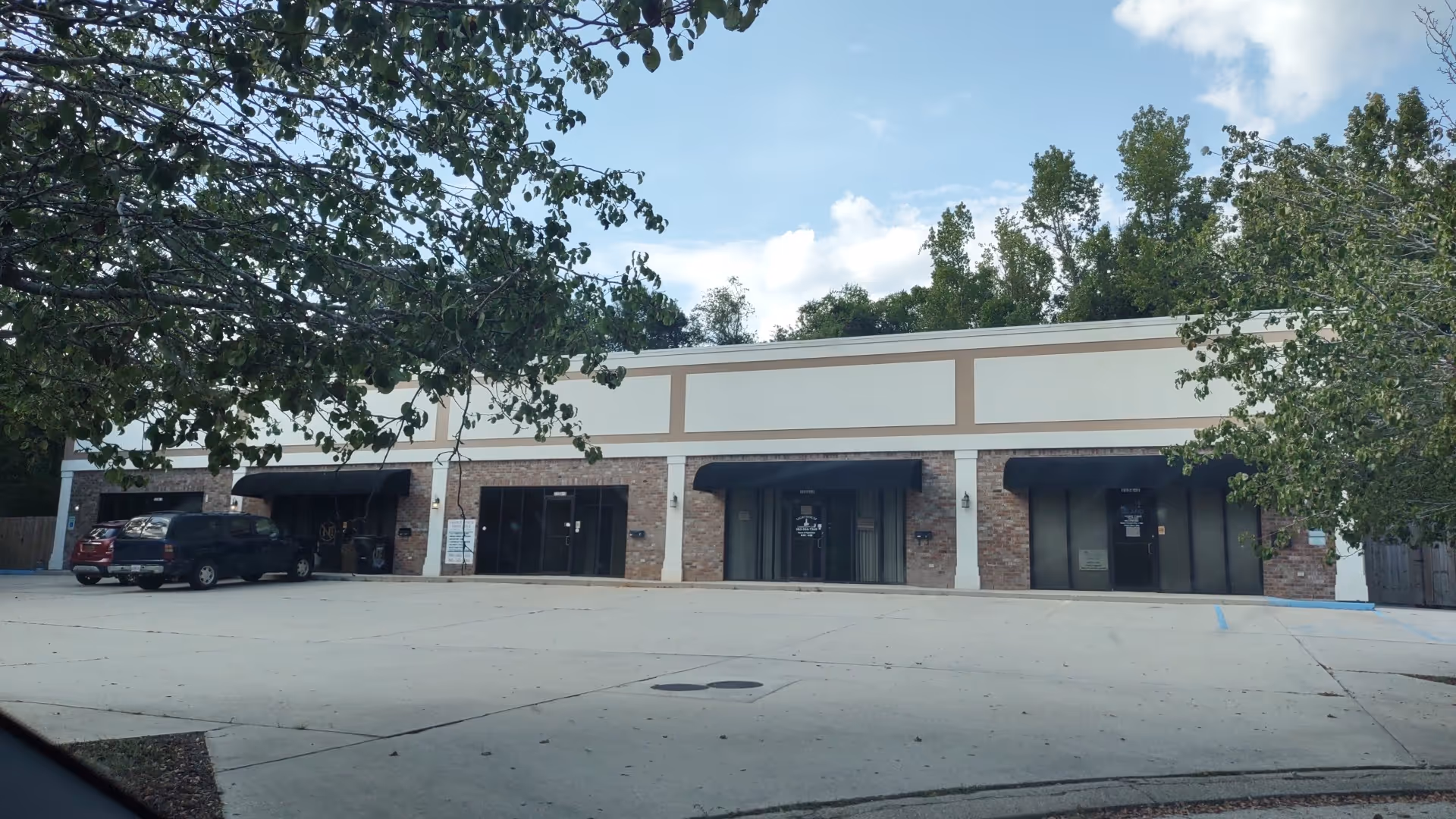 Exterior of Island Home Care facility with brick storefronts and a parking lot.