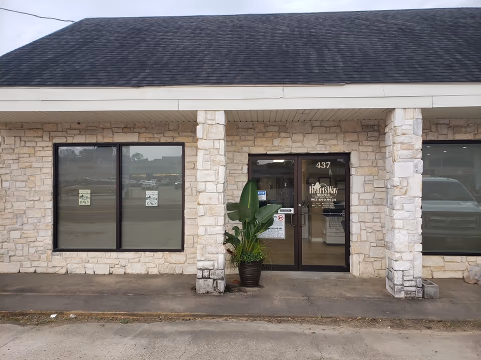 Front view of HeartsWay Hospice Carthage Office building with stone facade.