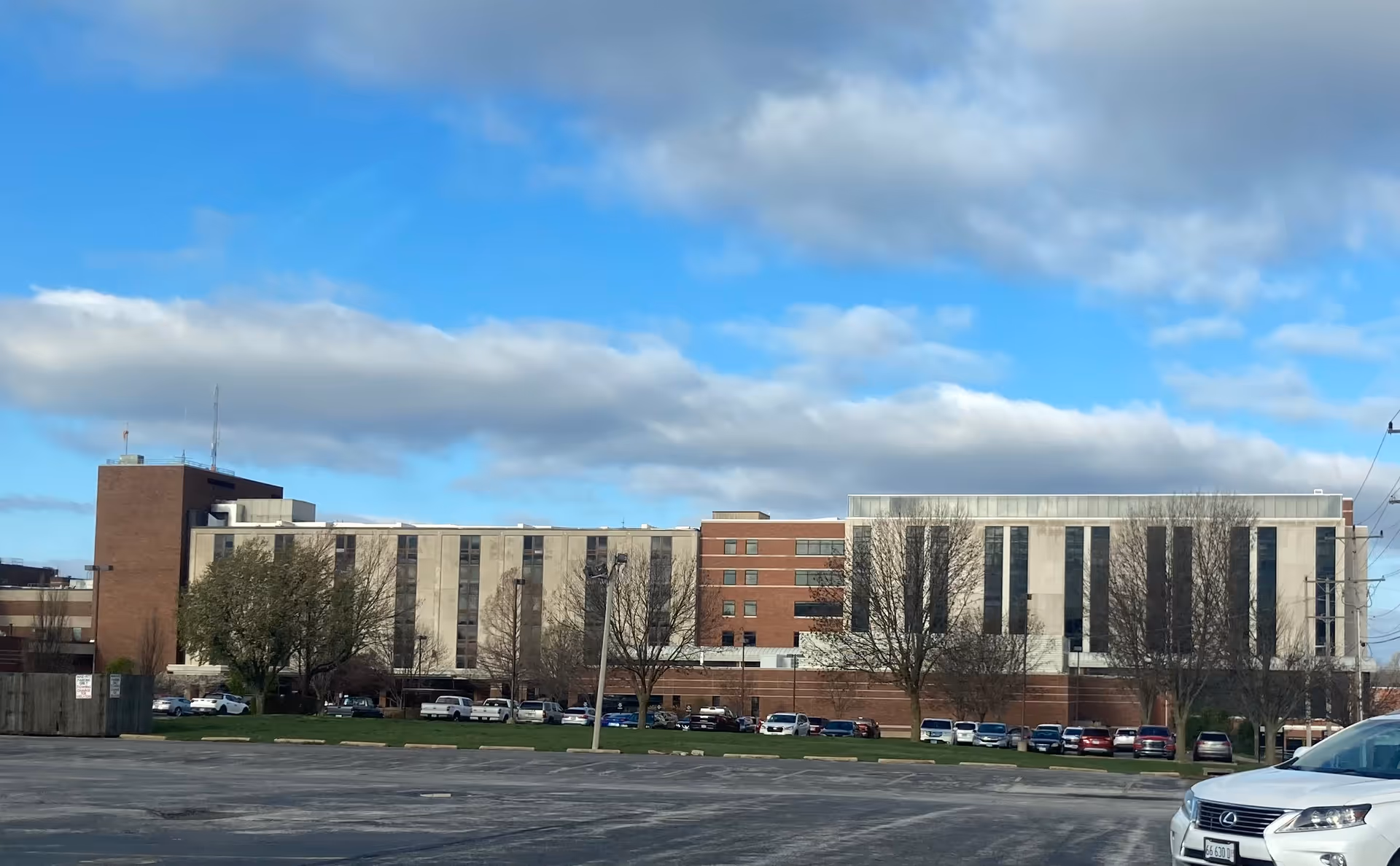 Exterior of Blessing Hospital building with parking lot and leafless trees.
