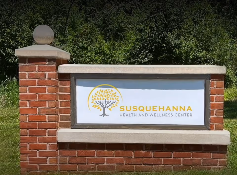 Brick entrance sign for Susquehanna Health and Wellness Center outdoors.