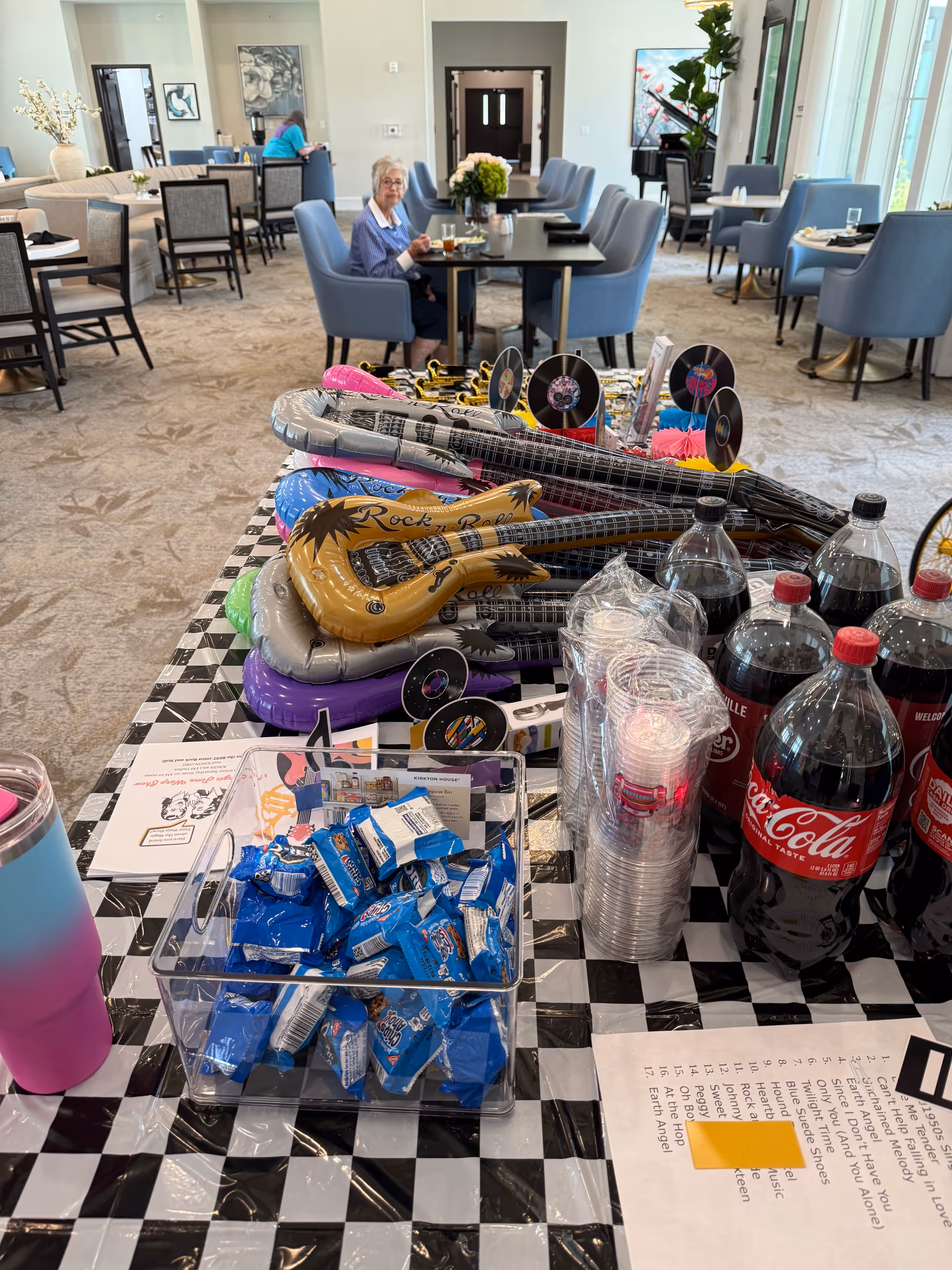 Bright senior living dining area with a festive foreground table of drinks and decorations.