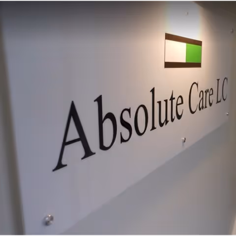 Interior wall displaying the Absolute Care LC sign and logo.